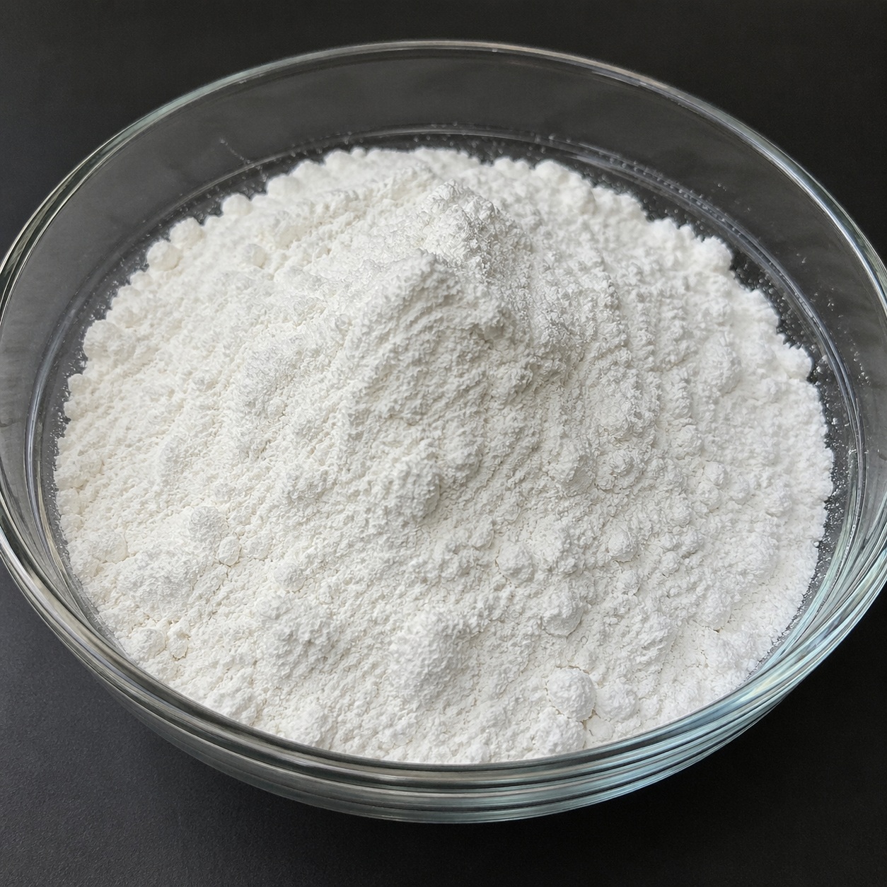 Allenton Allantoin fine white crystalline powder in a glass bowl used for soothing and skin-repair cosmetic formulations.