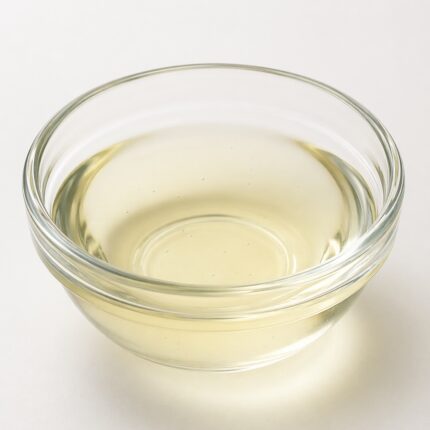 Cocamidopropyl Betaine clear to pale liquid in a glass container used as a mild surfactant and foam booster in personal care formulations.