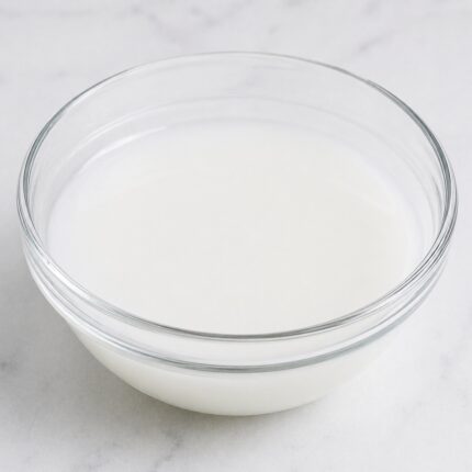 Amodimethicone, Cetrimonium Chloride, and Trideceth-12 milky liquid in glass container used as conditioning and smoothing system in hair care formulations