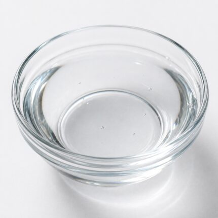 Clear, colorless viscous liquid of Dimethicone 200/350 cSt in a glass container, used as a silicone fluid for smoothness and conditioning in cosmetic formulations.