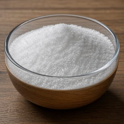 Kojic acid fine white crystalline powder in a glass bowl used for skin brightening and cosmetic formulations.