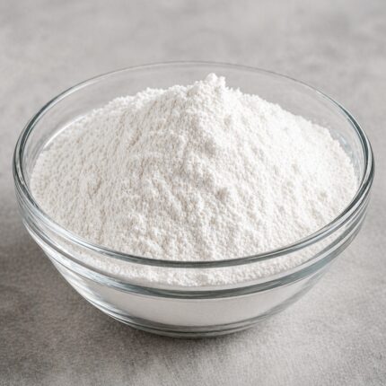Butylparaben powder in a glass container, showing its fine white crystalline texture.