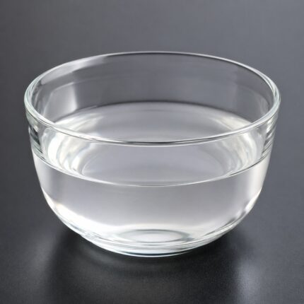 Butylene glycol liquid in a clear glass container, showing its colorless, transparent appearance.