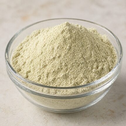 Hydrolyzed pea protein powder in a glass container, showing its fine light beige to off-white texture.