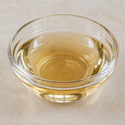 Hydrolyzed silk protein liquid in a clear bottle, showing its transparent to pale yellow fluid appearance.