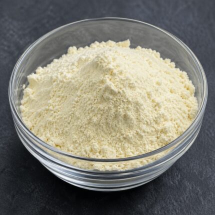 Sodium cocoyl taurate powder in a glass container, showing its fine white to off-white granular texture.