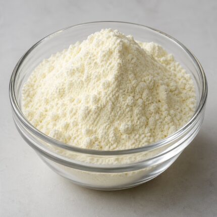 Sodium methyl cocoyl taurate powder in a glass container, showing its fine white granular texture.