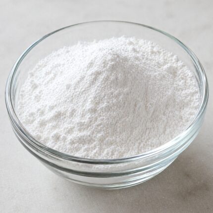 Sodium propyl paraben powder in a glass container, showing its fine white crystalline texture.