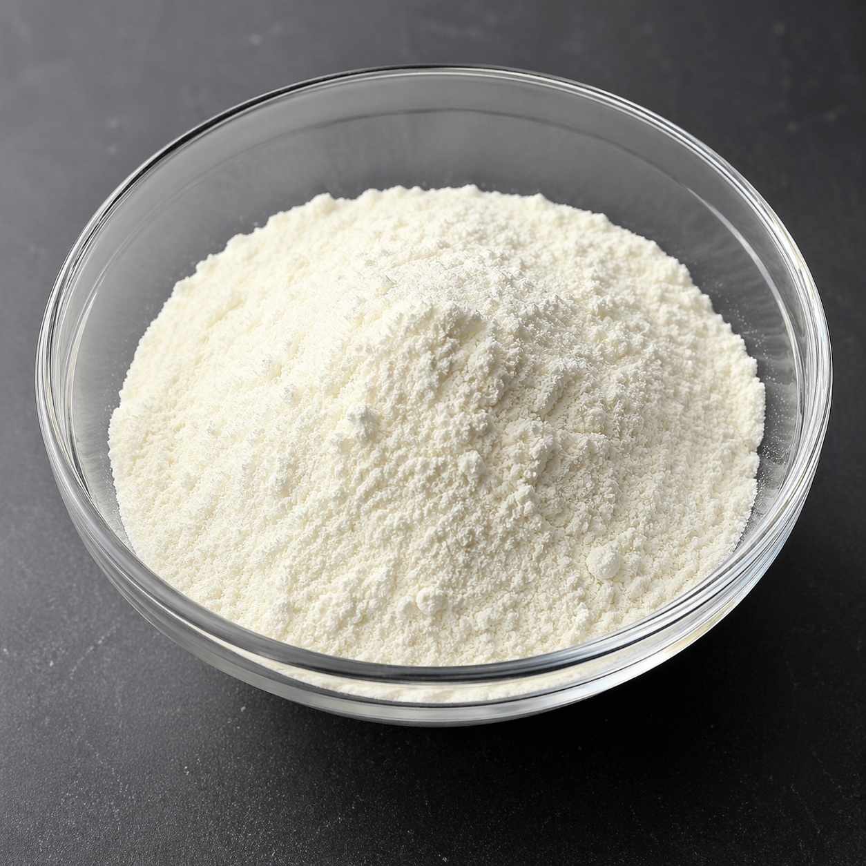 Tranexamic Acid Powder Tranexamic acid fine white crystalline powder in a glass container, commonly used in pharmaceutical and skincare formulations for its anti-fibrinolytic and skin-brightening properties.