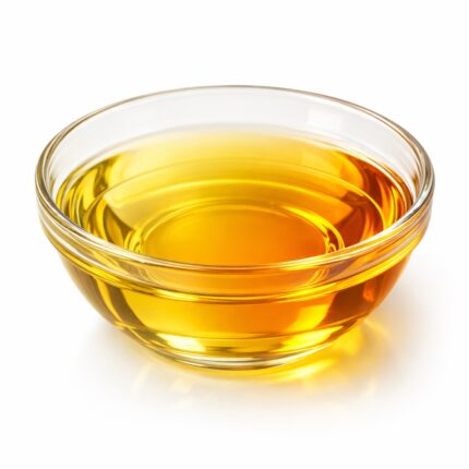 Vitamin K liquid in clear glass bowl, pale yellow to amber color Transparent Vitamin K oil with golden tint in glass container Vitamin K solution showing light yellow clear liquid texture Cosmetic grade Vitamin K liquid in glass bowl on white background Pure Vitamin K oil with amber hue in minimal setup