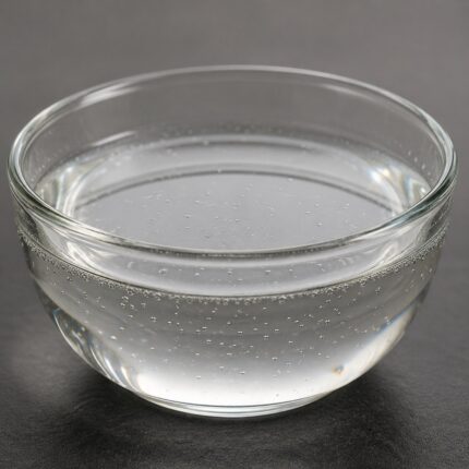 Clear to slightly hazy liquid of Xylishine in a glass container, smooth texture and glossy appearance.