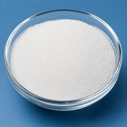 Ethylparaben powder in a glass container, showing its fine white crystalline texture.