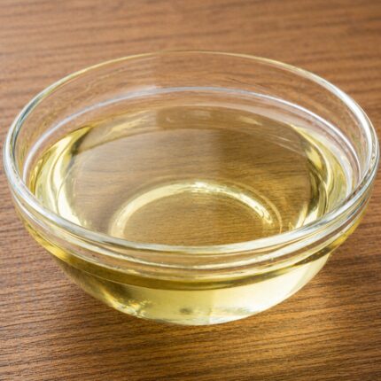 Hydrolyzed keratin liquid in a clear bottle, showing its transparent to light amber fluid appearance.