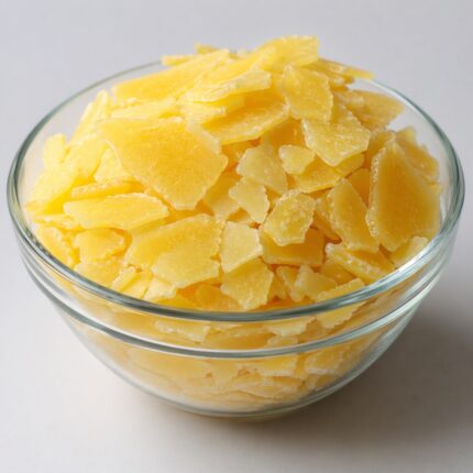 Off-white to pale yellow waxy Stearamidopropyl Dimethylamine flakes with smooth texture, commonly used in hair-conditioning formulations.